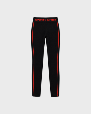 Badir Bold Logo Alpine Legging in black, featuring a high waist, red side stripe, and red text on the waistband.