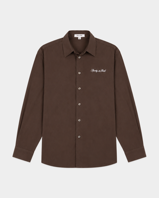 Cora Signature Logo BD Shirt in chocolate garment-dyed cotton with white cursive logo embroidery on the chest.