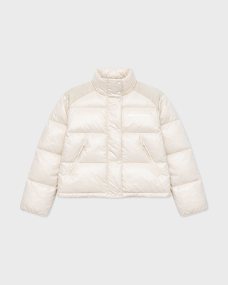 A cream-colored puffer jacket with a stand-up collar and zippered front, displayed on a light gray background.