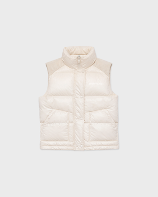 Cream-colored Devano Bold Logo Mountain Puffer Vest for cold-weather training, featuring a high collar and chest logo.