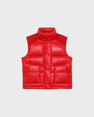 A bright red sleeveless puffer vest with a high collar and front zipper, featuring the white text 'SPORTY & RICH' on the left chest, displayed against a light gray background.