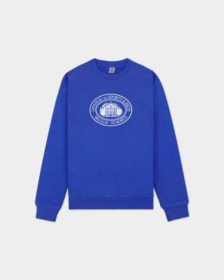 A royal blue crewneck sweatshirt with a white circular graphic printed on the chest, displayed flat against a light gray background.
