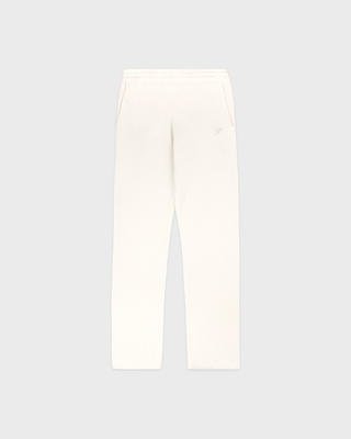 A pair of off-white fleece pants with a small tonal embroidered logo on the left thigh, displayed flat against a light gray background.
