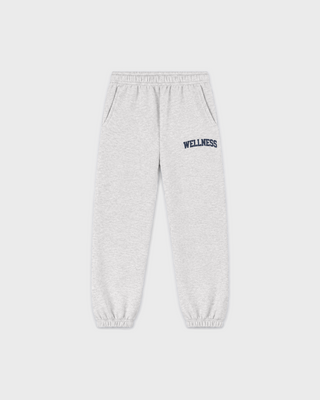 Kais Wellness Ivy Kids Jogger in heather gray with WELLNESS printed in dark blue on the left hip.