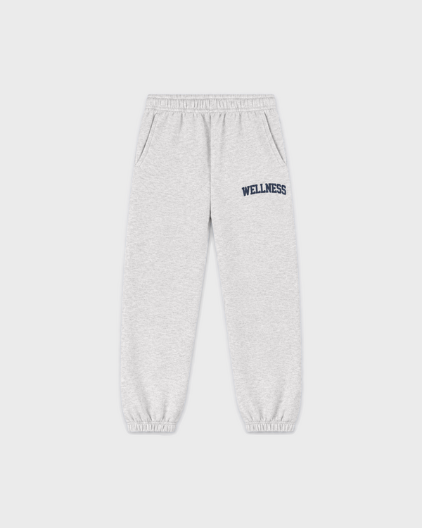 Kais Wellness Ivy Kids Jogger in heather gray with WELLNESS printed in dark blue on the left hip.