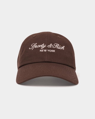 Maeve Vendome Script Hat - Chocolate: brown unstructured baseball cap with white Sporty & Rich NEW YORK embroidery.