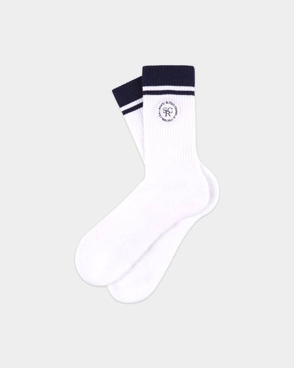 Introducing the Sama SRHWC Socks in White/Dark Navy: classic white crew sport socks featuring dark navy stripes at the top and a circular logo near the cuff, expertly crafted from soft cotton for ultimate comfort and everyday wear.