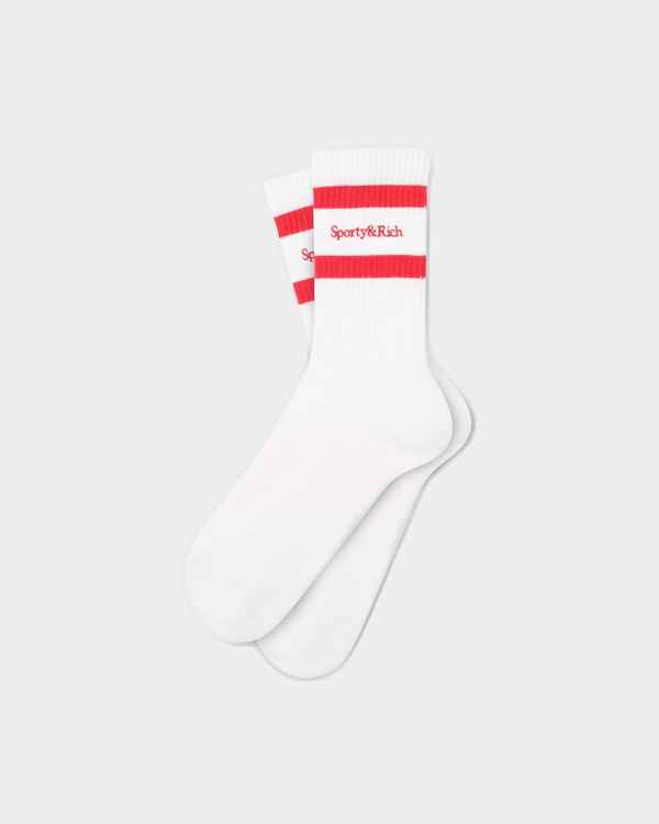 A pair of Saori Serif Logo Socks in off white with ruby accents, featuring two red stripes and Sporty & Rich branding near the top, crafted from breathable cotton for all-day comfort.