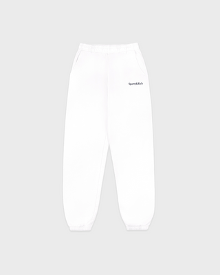 The Brianno Serif Logo Embroidered Jogger in White features elastic cuffs and waistband, front pockets, and a small embroidered Sporty & Rich logo on the left hip, offering a classic jogger fit inspired by their iconic sweatpants.