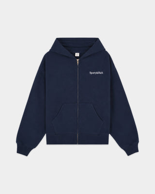 Emaro Serif Logo Embroidered Zip Hoodie in Dark Navy, laid flat. This relaxed fit hoodie features front pockets, an embroidered Sporty & Rich logo on the left chest, and an ultra-soft feel for everyday comfort.