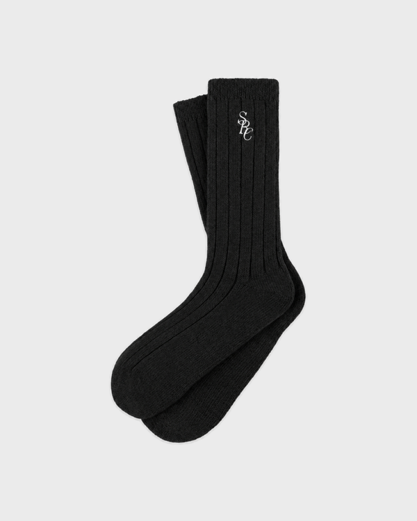 Pair of black Sole SRC Wide Rib Cashmere Socks with white logo embroidery on the cuff.