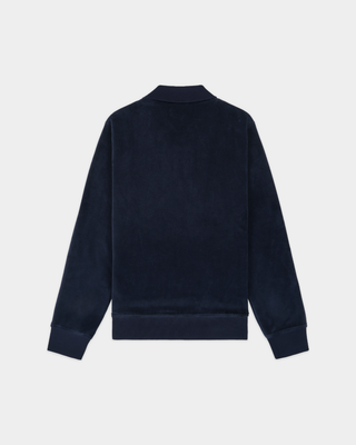Woman in the Amanda S Logo Longsleeve Velour Polo - Dark Navy, with braided hair, standing against a plain light background.