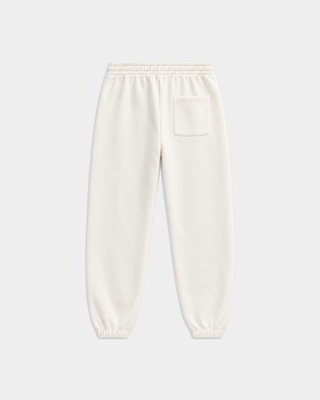 Wearing the Brianno SR Hotel Jogger in Off White and a white hoodie, the person completes their look with yellow-accented sneakers while standing against a plain white background.