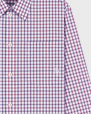 The Coco SRC Oversized Shirt - Blue White Red Check is a long-sleeve button-up featuring a small red, blue, and white checkered pattern, crafted from breathable poplin and displayed laid flat on a white surface.