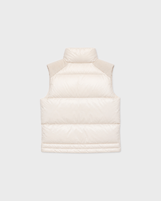 Cream-colored Devano Bold Logo Mountain Puffer Vest for cold-weather training, featuring a high collar and chest logo.