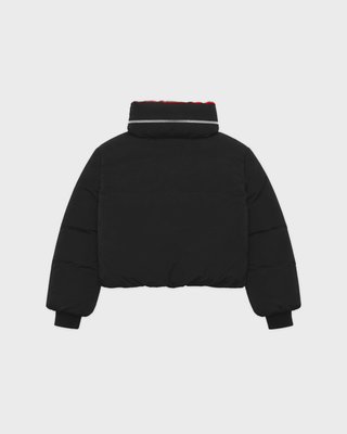 Drea Bold Logo Ski Jacket in black with an oversized fit, red interior collar, and red sleeve text.