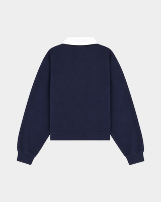 Evin Serif Logo Embroidered Polo in Dark Navy/White, featuring a vintage varsity-inspired cropped boxy fit, contrast white collar, and Sporty & Rich text embroidered on the left chest; displayed flat-lay on a white background.