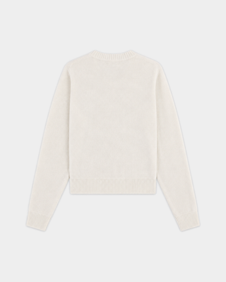 The Iba S Logo Cashmere Henley in Off White features long sleeves, ribbed cuffs and hem, and a three-button placket at the collar. Crafted from a luxurious cashmere-wool blend, this sweater offers both warmth and timeless style.