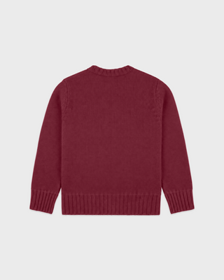 A merlot knit crewneck sweater with a white graphic print on the front reading 'SPORTY & RICH CALIFORNIA' around a crest emblem, shown flat against a light gray background.