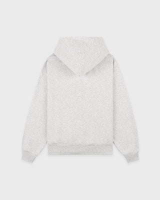 The Emaro Serif Logo Embroidered Zip Hoodie in Heather Gray is laid flat, showcasing its light gray color, zip-up front, front pockets, and a small white embroidered logo on the left chest. This super soft hoodie offers a relaxed fit for ultimate comfort.
