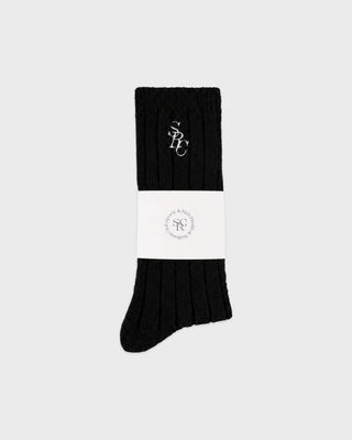 Pair of black Sole SRC Wide Rib Cashmere Socks with white logo embroidery on the cuff.