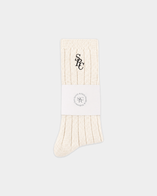 Sole SRC Wide Rib Cashmere Socks in cream, featuring a ribbed texture and an embroidered logo at the cuff.