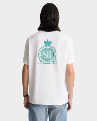 Person wearing the Royal Club T-Shirt in white with a spring green SR crest, paired with blue jeans and shown from the back.