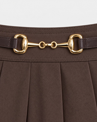 Chocolate Anais Riding Skirt featuring a pleated design and gold-tone horsebit hardware at the waist.