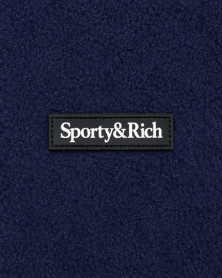 Ezia Serif Logo Zipped Polar Fleece in dark navy and white, featuring a white zipper and pocket accents, plus an adjustable hem for a tailored fit—ideal as a cozy winter layer, shown laid flat on a white background.