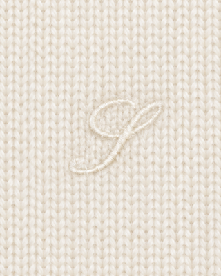 The Iba S Logo Cashmere Henley in Off White features long sleeves, ribbed cuffs and hem, and a three-button placket at the collar. Crafted from a luxurious cashmere-wool blend, this sweater offers both warmth and timeless style.