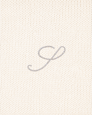 Ivana S Logo Cashmere Trousers in cream, featuring a wide-leg knit, drawstring waist, and embroidered hip logo.