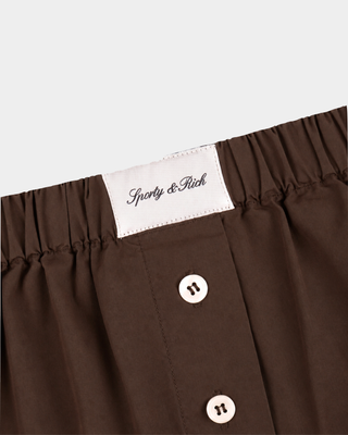 Loly Signature Logo Ring Short in chocolate, a breathable cotton boxer-style short with an elastic waist and button fly.