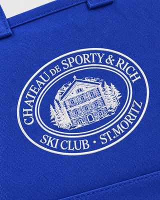 Vibrant blue Maya Chateau OG Tote with a white circular logo featuring a building and Chateau de Sporty & Rich text.