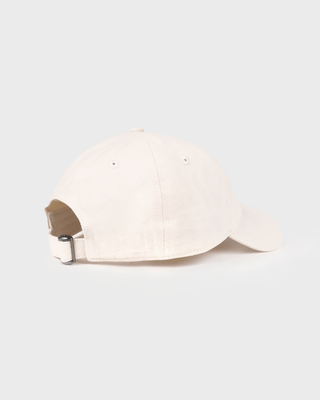 A light beige baseball cap with 'Sporty&Rich' embroidered in navy blue on the front, set against a solid light gray background.