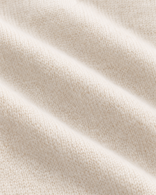 The Iba S Logo Cashmere Henley in Off White features long sleeves, ribbed cuffs and hem, and a three-button placket at the collar. Crafted from a luxurious cashmere-wool blend, this sweater offers both warmth and timeless style.