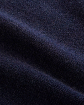 Izar S Logo Cashmere Polo in dark navy, a long-sleeve knit sweater crafted from a luxurious cashmere-wool blend, featuring a classic buttoned collar with three buttons, shown laid flat on a white background.