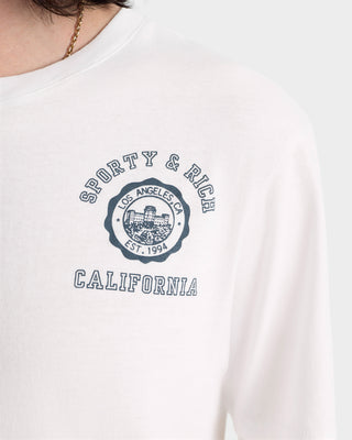 The California Emblem Soft T-Shirt - White is an oversized tee made in Portugal, featuring Sporty & Rich California and Los Angeles CA Est. 1994 printed on the chest.