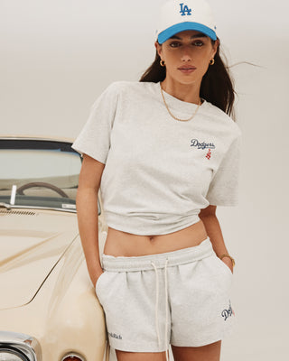 Model stands by a vintage car in her LA cap and Dodgers Serif Disco Short in Heather Gray/Navy, showcasing a chic, casual look.