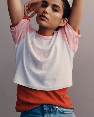 Person wearing a colorful shirt with 'Yankee' branding against a plain background