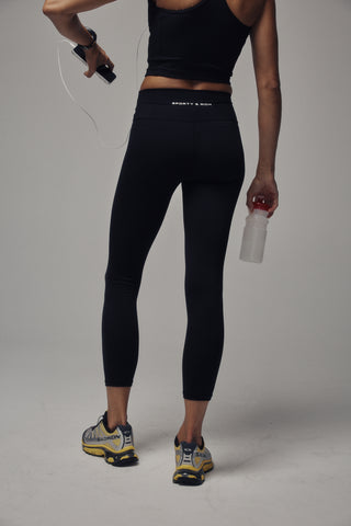 Black high-waisted leggings shown on a ghost mannequin against a light gray background.