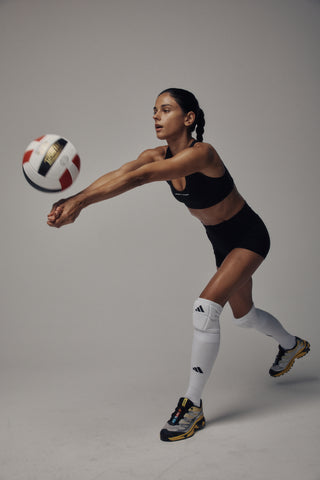 The Florian Bold Logo Active Bra in black features a racerback silhouette with bold white SPORTY & RICH text centered on the front, providing comfortable support for your workouts and shown against a light background.