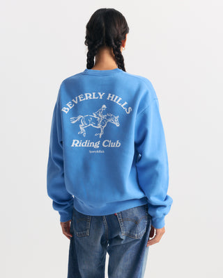 True blue Emmett Bh Riding Club Crewneck featuring a white graphic of a horse and rider on the left chest.