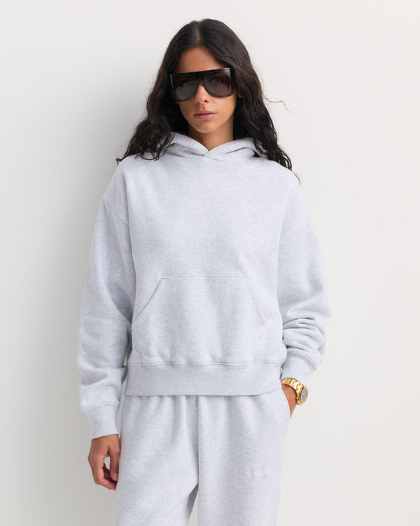 Edito Serif Logo Embroidered Hoodie in heather gray, showcased flat on a white background. This unisex 100% cotton hoodie features a front pocket and a timeless design that blends comfort with effortless style.