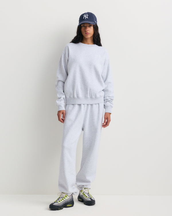 Heather gray Brianno Serif Logo Embroidered Jogger with an elastic waistband and cuffs, featuring side pockets and a small embroidered white serif logo on the left hip—a classic jogger fit inspired by the signature Sporty & Rich sweatpant.