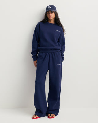 Dark navy Eeva Serif Logo Embroidered Crewneck featuring embroidered text on the upper left chest, laid flat on a white background.