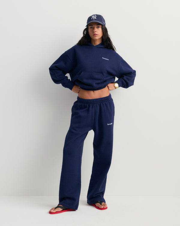 Besma Serif Logo Embroidered Baggy Sweatpant in dark navy, featuring an oversized fit with an elastic waistband and side pockets, laid flat on a white background.