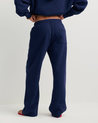 Basilo Serif Logo Embroidered Wide Sweatpant in dark navy, featuring an elastic waistband and a small white embroidered logo on the left thigh.