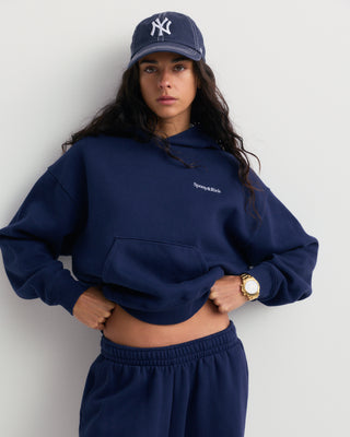Basilo Serif Logo Embroidered Wide Sweatpant in dark navy, featuring an elastic waistband and a small white embroidered logo on the left thigh.