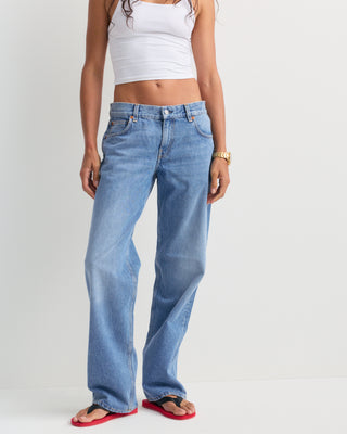 Baggy Jean - Light Wash: Classic high-waisted, straight-leg denim jeans in a light blue wash with subtle fading, featuring a five-pocket design and relaxed baggy fit, displayed on a white background.