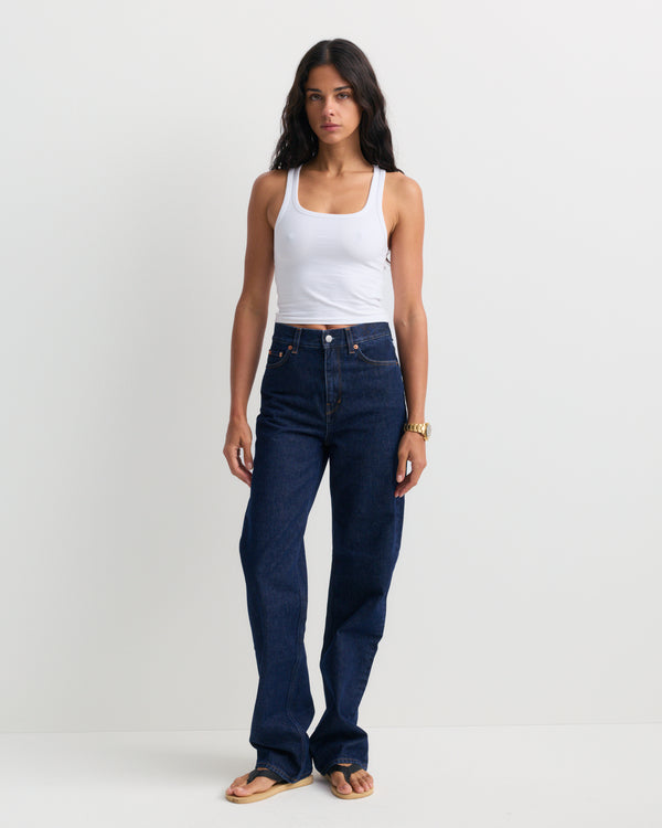 Loose Jean - One Wash, featuring a dark blue wash, high-rise fit, straight-leg silhouette, front pockets, belt loops, and a button closure, shown laid flat on a white background.